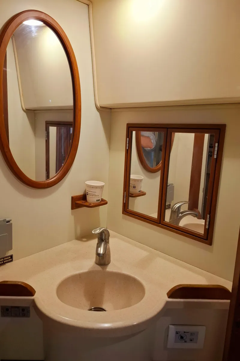 Slide: The Image of 2003 Island Packet 485 yacht bathroom with oval mirror and sink. - 30