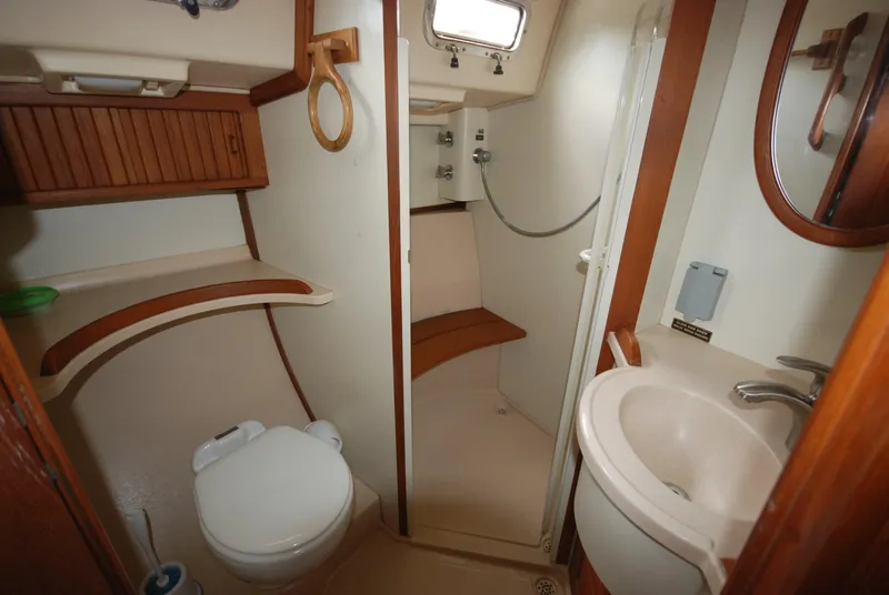 Slide: The Image of 2003 Island Packet 485 yacht bathroom with shower, sink, and toilet. - 31