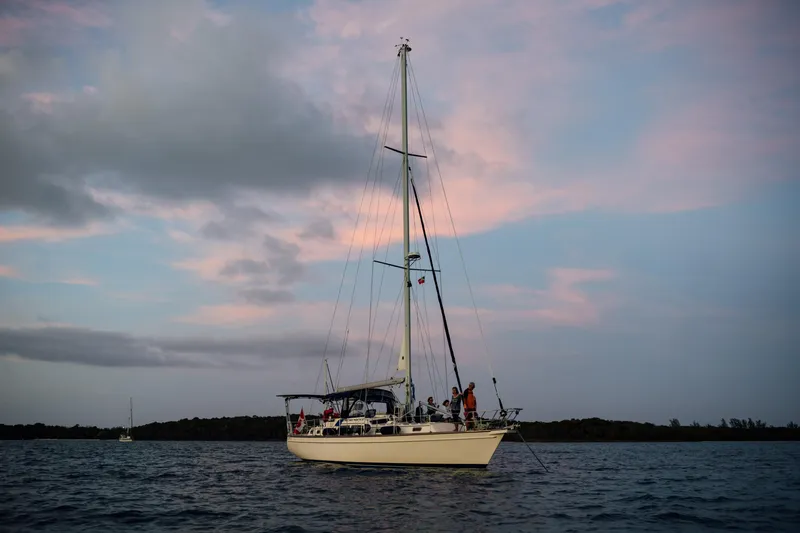 Slide: The Image of Sailboat Island Packet 485, 2003 model, on calm waters at sunset. - 40