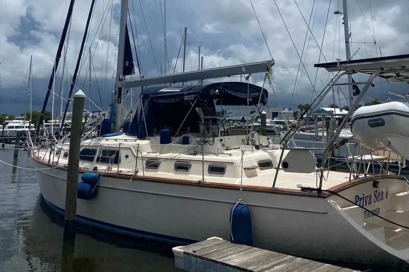 Slide: The Image of 2003 Island Packet 485 sailboat docked at marina under cloudy skies. - 5