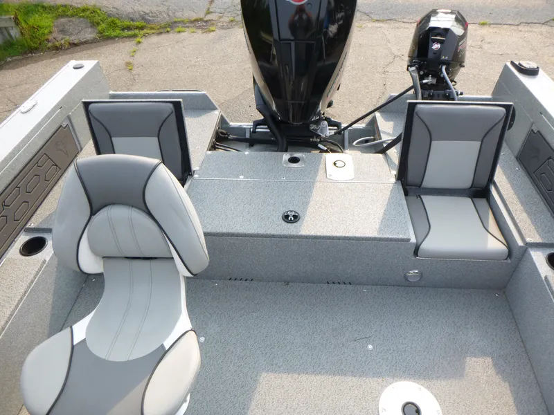 Slide: The Image of 2025 KingFisher 2125 Arrow Sport boat interior with gray seating and motor. - 10