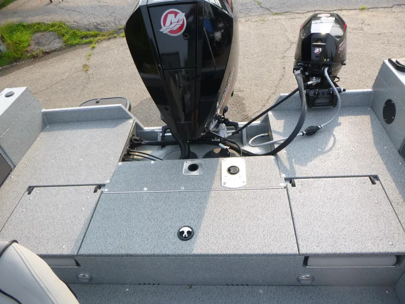 Slide: The Image of 2025 KingFisher 2125 Arrow Sport boat with dual outboard motors on a textured deck. - 11