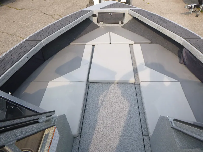 Slide: The Image of 2025 KingFisher 2125 Arrow Sport boat interior with cushioned seating and storage. - 14