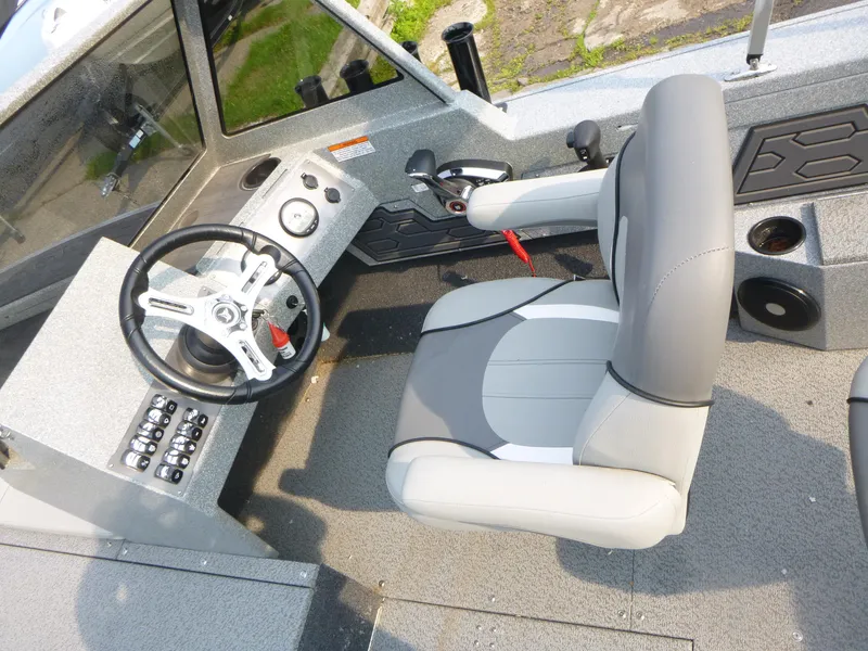 Slide: The Image of Interior of 2025 KingFisher 2125 Arrow Sport boat, featuring steering wheel and captain's chair. - 7