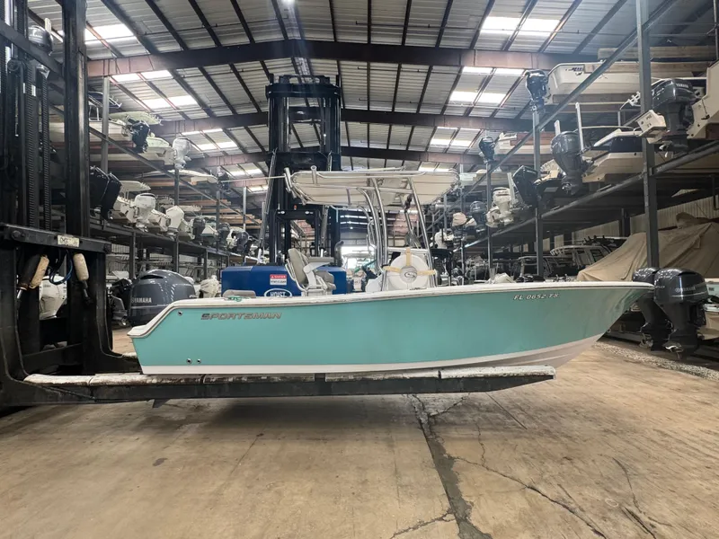 Slide: The Image of 2023 Sportsman 212 boat in storage facility, surrounded by other boats and equipment. - 12