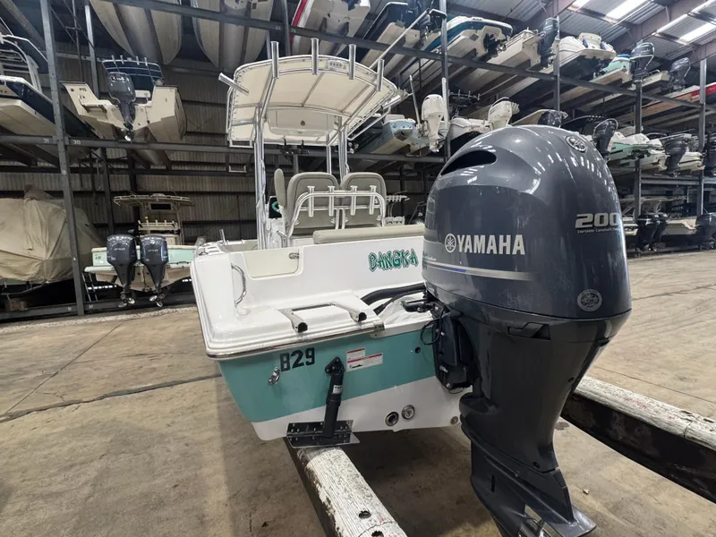 Slide: The Image of 2023 Sportsman 212 boat with Yamaha 200 engine in storage facility. - 4