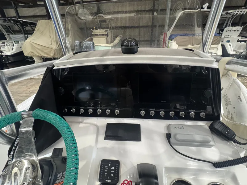 Slide: The Image of Control panel of 2023 Sportsman 212 boat with navigation equipment and steering wheel. - 6
