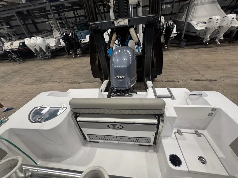 Slide: The Image of 2023 Sportsman 212 boat with 200 horsepower engine in a showroom. - 9
