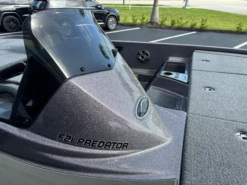 Slide: The Image of 2025 Falcon Boats 21 Predator with Minn Kota Raptor motor, displayed outdoors. - 10