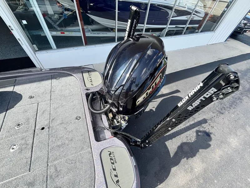 Slide: The Image of 2025 Falcon Boats 21 Predator with Yamaha engine in a covered storage area. - 11