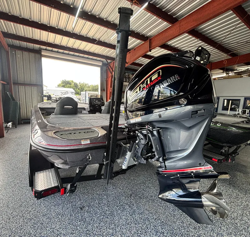 Slide: The Image of 2025 Falcon Boats 21 Predator with Yamaha outboard motor, parked outdoors under a blue sky. - 12