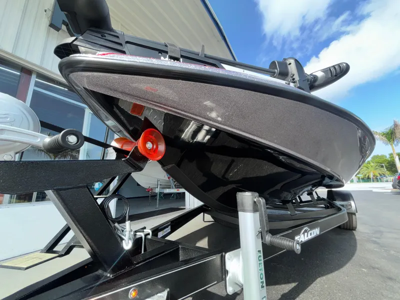 Slide: The Image of 2025 Falcon Boats 21 Predator on trailer, parked outdoors with palm trees in background. - 5