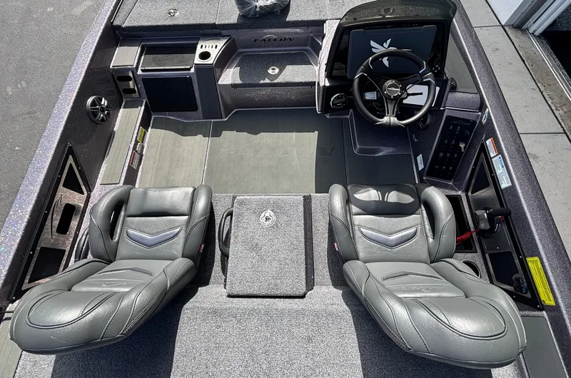 Slide: The Image of 2025 Falcon Boats 21 Predator with spacious deck, parked in a sunny lot. - 17