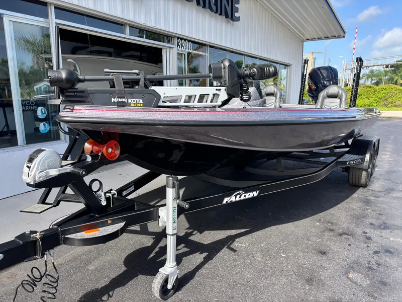 Slide: The Image of 2025 Falcon Boats 21 Predator on trailer, parked outdoors with palm trees in background. - 2