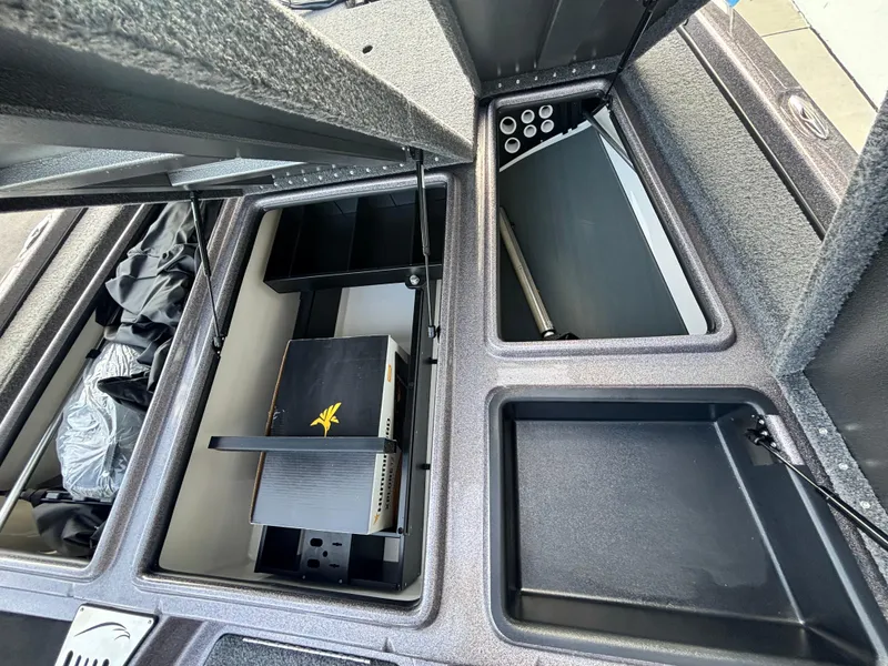 Slide: The Image of Interior of 2025 Falcon Boats 21 Predator, featuring storage and speaker system. - 22