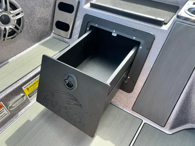 Slide: The Image of 2025 Falcon Boats 21 Predator interior storage compartment with cup holder and sleek design. - 24