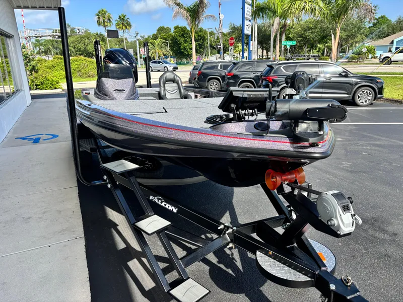 Slide: The Image of 2025 Falcon Boats 21 Predator on trailer, parked outdoors with palm trees and clear sky. - 3