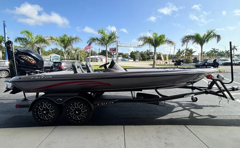 Slide: The Image of 2025 Falcon Boats 21 Predator on trailer, parked outdoors with palm trees in background. - 6