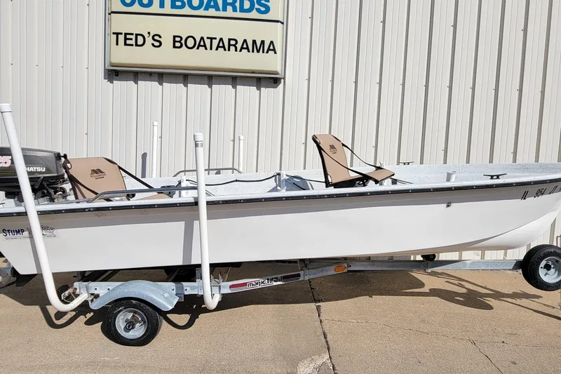 The Image of 1996 DILKES STUMP JUMPER boat on trailer at Ted's Boatarama, featuring Tohatsu outboard motor. - 0