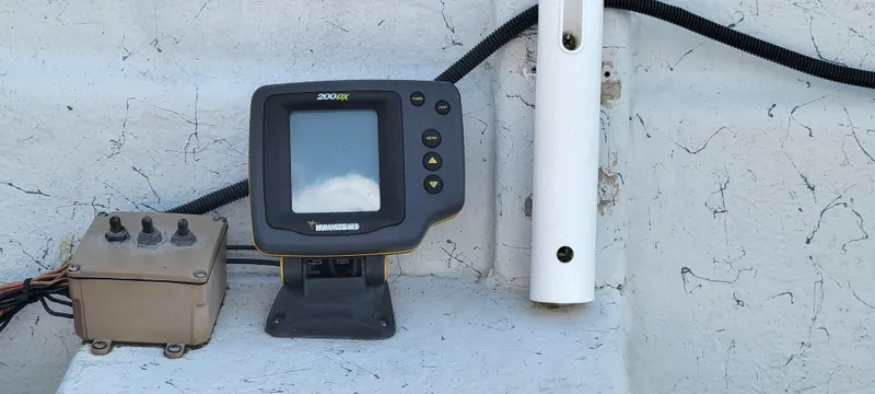 Slide: The Image of Fishfinder and control panel on a 1996 Tracker Pro Angler V 16 boat. - 12