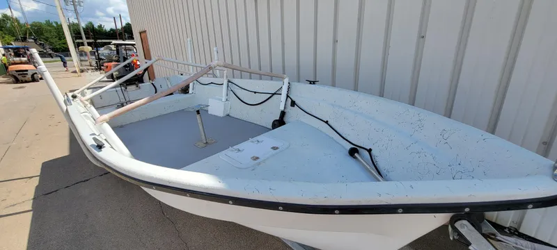 Slide: The Image of 1996 Tracker Pro Angler V 16 boat, white exterior, docked beside a building. - 16