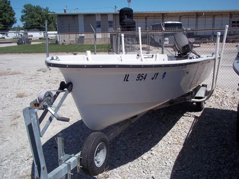 Slide: The Image of 1996 Tracker Pro Angler V 16 boat on trailer, parked in gravel lot. - 18
