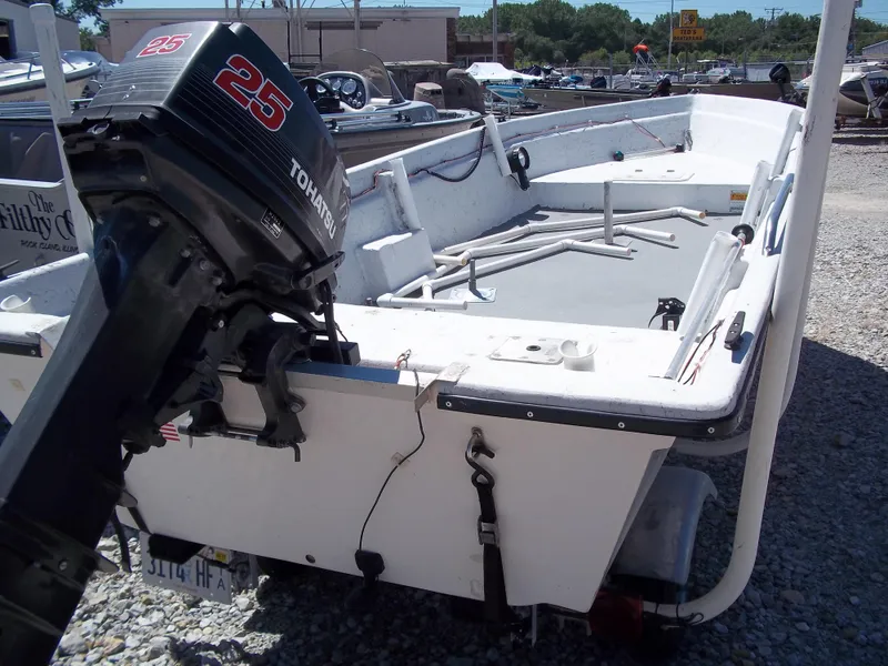 Slide: The Image of 1996 Tracker Pro Angler V 16 boat with Tohatsu 25 outboard motor, parked on gravel. - 25