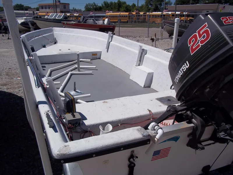 Slide: The Image of 1996 Tracker Pro Angler V 16 boat with Tohatsu 25 outboard motor, parked outdoors. - 26