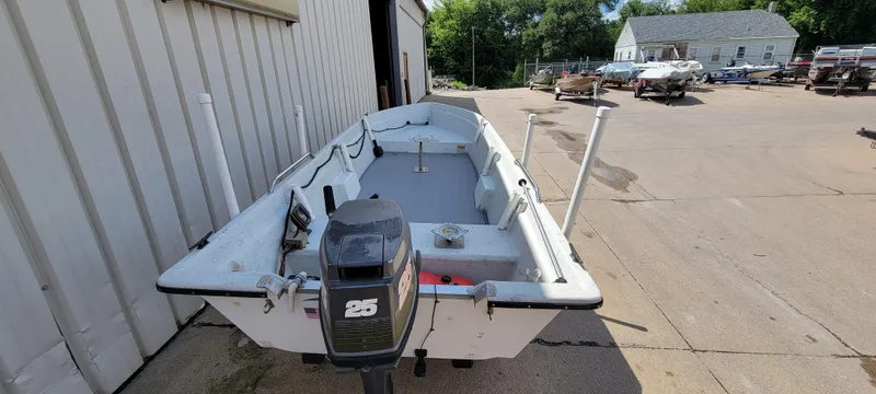 Slide: The Image of 1996 Tracker Pro Angler V 16 boat with outboard motor in a boatyard. - 8