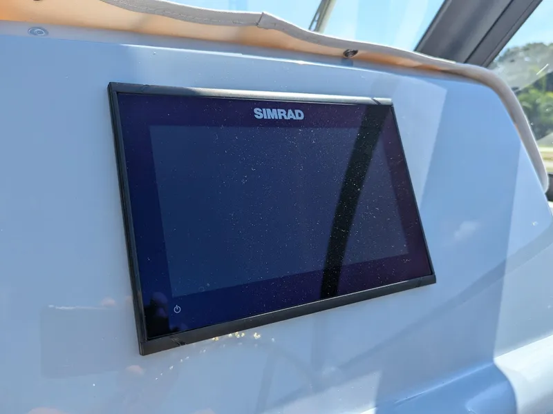 Slide: The Image of Simrad display on 2026 Bayliner Trophy T22SC boat dashboard. - 11