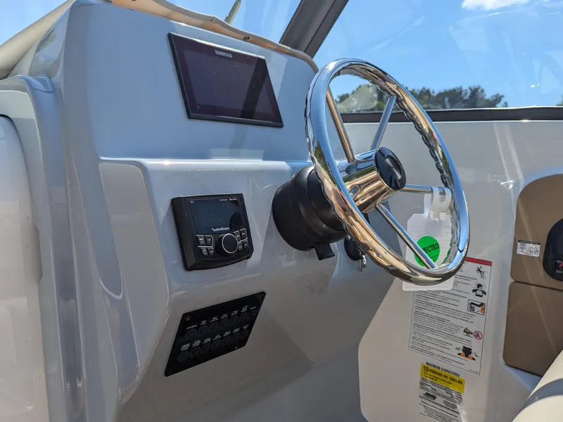 Slide: The Image of 2026 Bayliner Trophy T22SC helm with steering wheel and control panel. - 12