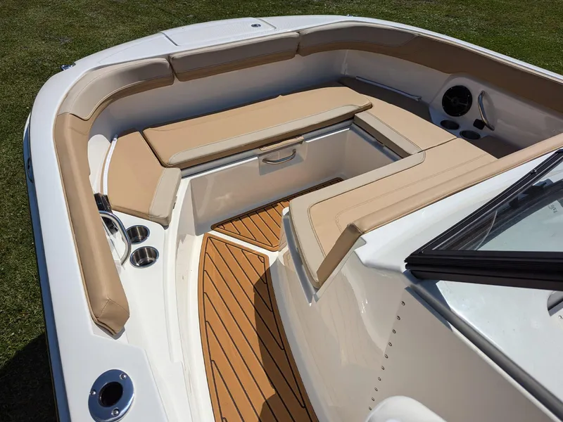 Slide: The Image of 2026 Bayliner Trophy T22SC boat interior with tan seating and wood-style flooring. - 13