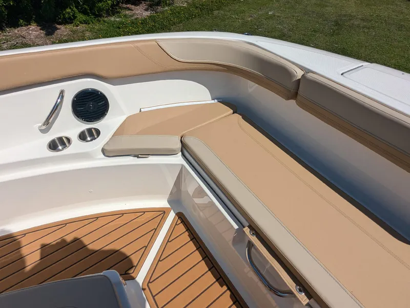 Slide: The Image of 2026 Bayliner Trophy T22SC boat interior with tan seating and cup holders. - 15