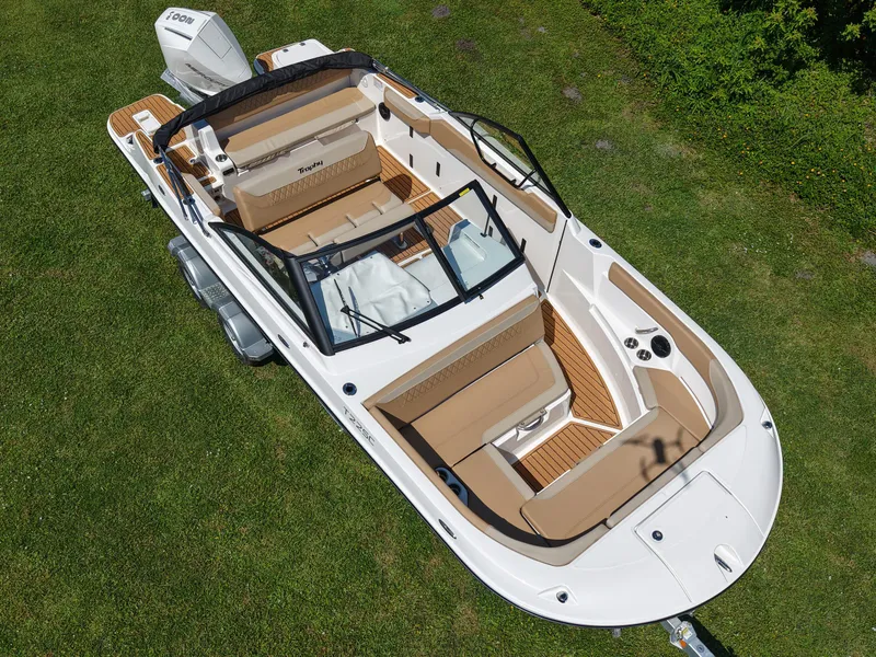 Slide: The Image of 2026 Bayliner Trophy T22SC boat on grass, showcasing sleek design and spacious seating. - 19