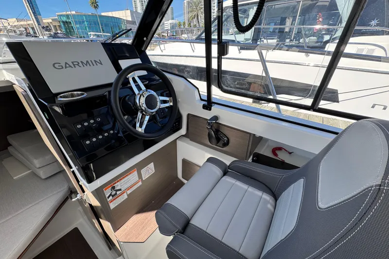 Slide: The Image of 2026 Jeanneau NC 795 Weekender helm with Garmin navigation system and comfortable seating. - 12