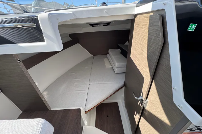 Slide: The Image of 2026 Jeanneau NC 795 Weekender cabin interior with modern design and comfortable seating. - 14