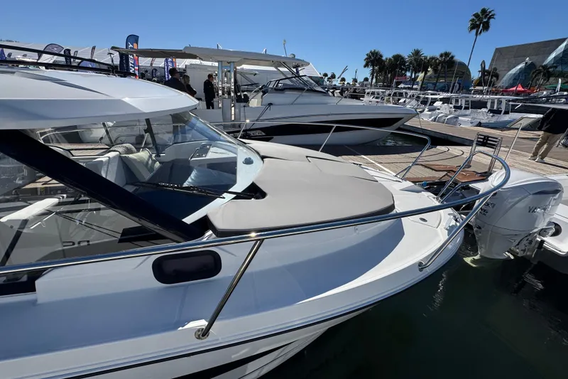 Slide: The Image of 2026 Jeanneau NC 795 Weekender boat docked at marina under clear blue sky. - 17
