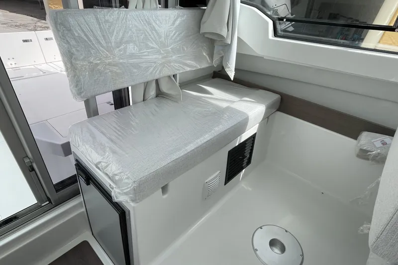 Slide: The Image of 2026 Jeanneau NC 795 Weekender boat docked under clear blue sky. - 4