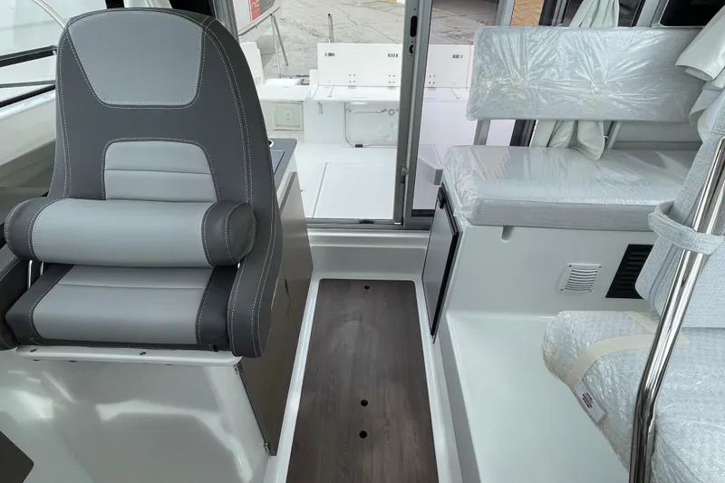 Slide: The Image of 2026 Jeanneau NC 795 Weekender interior with seating, table, and modern design. - 6