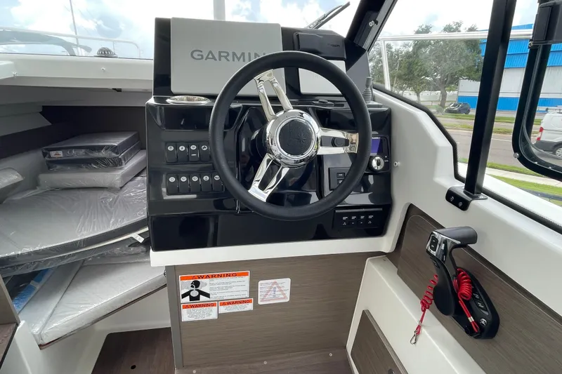 Slide: The Image of Interior of 2026 Jeanneau NC 795 Weekender boat, featuring modern seating and navigation area. - 8