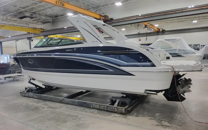 Slide: The Image of 2026 Formula 290 Bowrider boat in a warehouse, side view. - 2