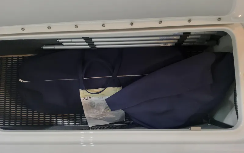 Slide: The Image of Storage compartment in 2026 Formula 290 Bowrider with folded equipment and cover. - 21