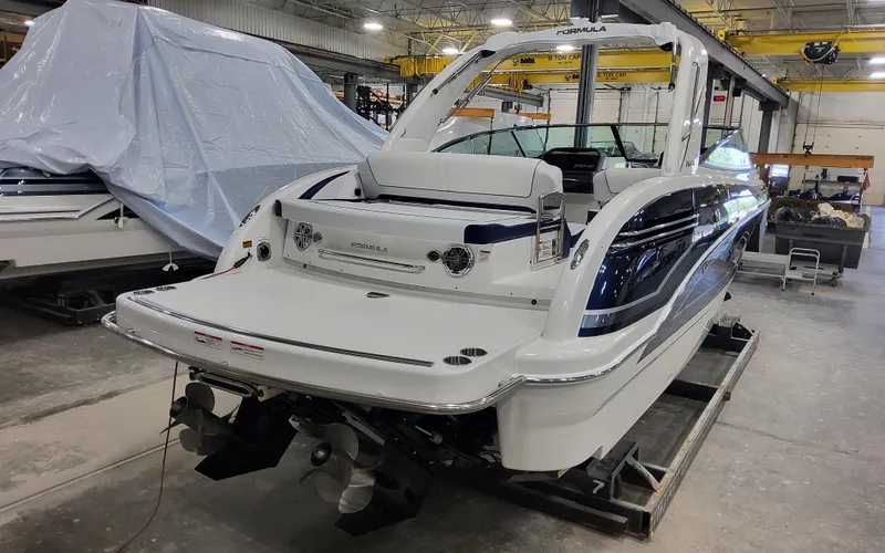 Slide: The Image of 2026 Formula 290 Bowrider boat in a workshop, showcasing sleek design and modern features. - 4