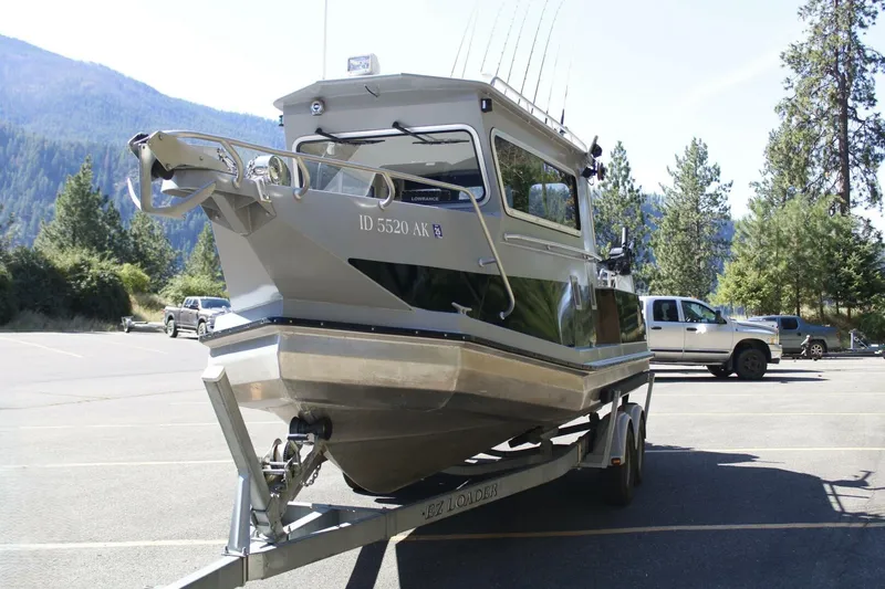 Slide: The Image of 2005 ACB 27 boat on trailer in scenic mountain parking lot. - 11