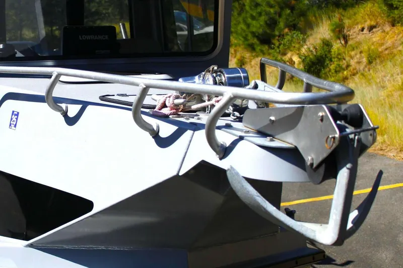 Slide: The Image of Bow of a 2005 ACB 27 boat with anchor and railing in sunlight. - 14