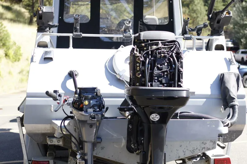 Slide: The Image of Rear view of a 2005 ACB 27 boat with exposed outboard motors. - 22