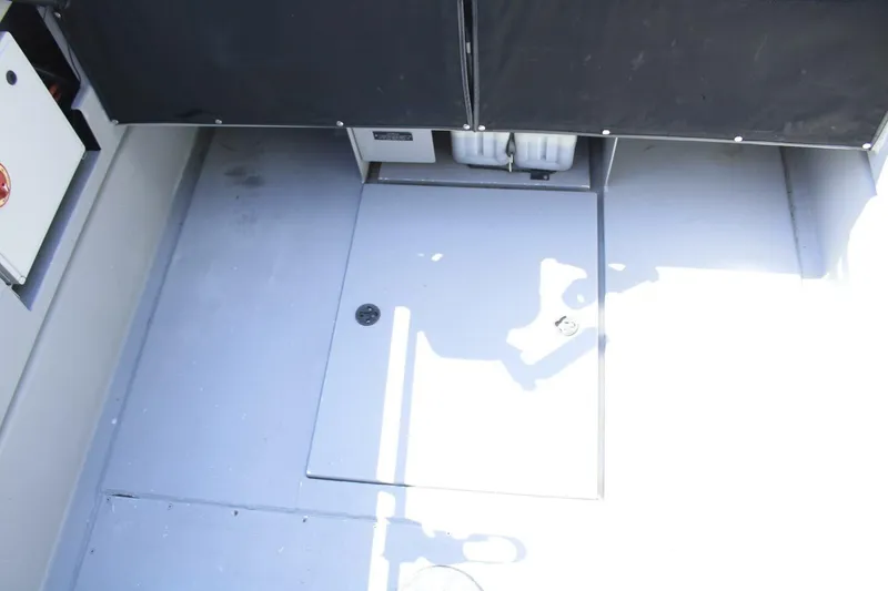 Slide: The Image of Interior view of a 2005 ACB 27 boat, featuring a clean, spacious deck area. - 27