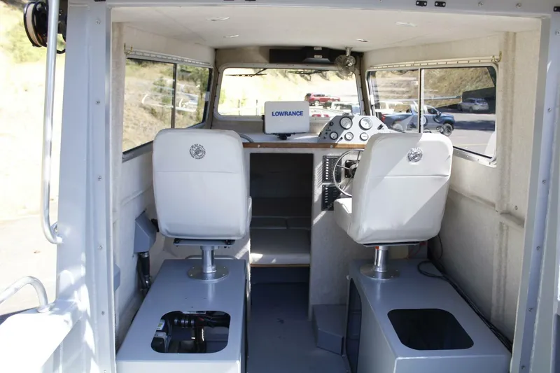 Slide: The Image of Interior of a 2005 ACB 27 boat with steering console and seating. - 40