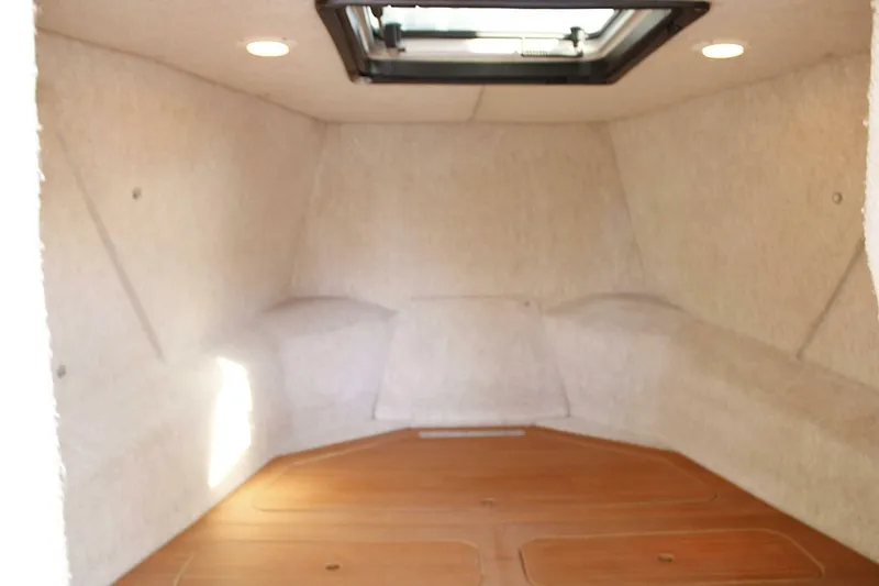 Slide: The Image of Interior cabin of 2005 ACB 27 boat with wooden flooring and overhead hatch. - 42