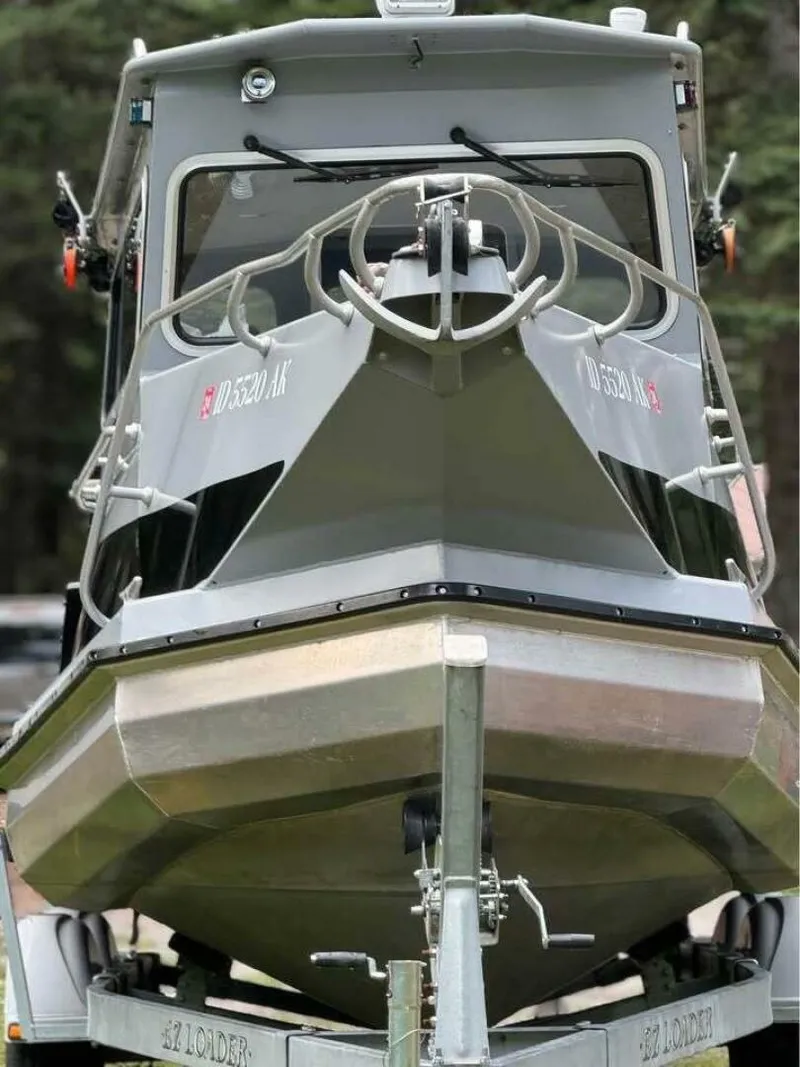 Slide: The Image of Front view of a 2005 ACB 27 boat on a trailer in a wooded area. - 55